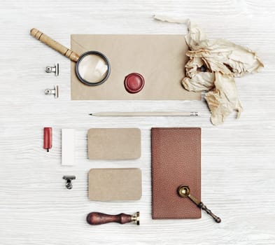 Blank vintage corporate stationery set on light wooden background. Template for branding design. Top view. Flat lay.