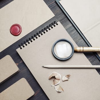Blank kraft stationery set on wood table background. Business brand template. Branding mock up. Top view. Flat lay.