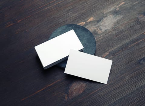 Photo of blank business cards on wooden background. Template for ID.