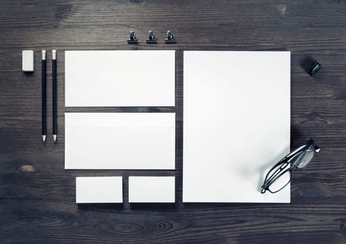 Photo of blank corporate stationery on wood table background. Branding mock-up. Top view. Flat lay.