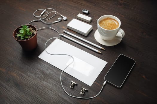 Photo of blank stationery set on wood table background. Responsive design template. Branding mock up. Blank objects for placing your design.