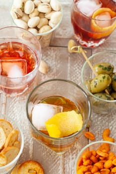Alcoholic drinks, cocktails on ice and salty snack, appetizers