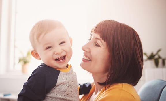 Happy mother holding in her arms her smiling son.. Concept of the family relationship and mother's love.