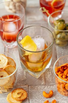 Alcoholic drinks, cocktails on ice and salty snack, appetizers
