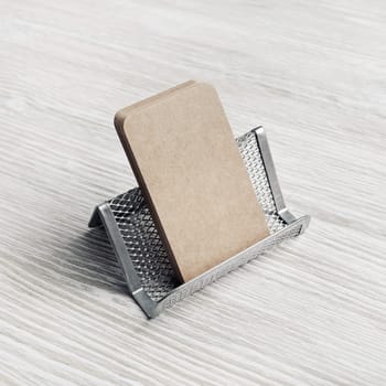 Photo of blank kraft business cards and card holder. Placing your design.