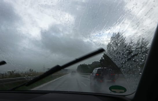 Heavy rain on a highway. Thunderstorm while driving a car