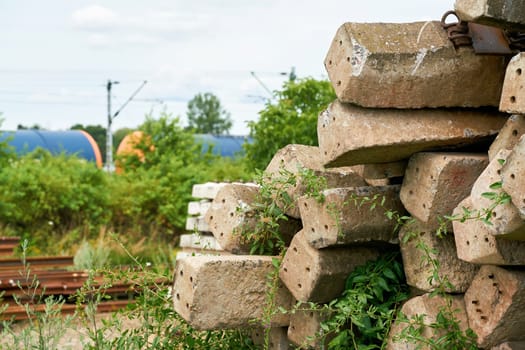 old no longer used overgrown and discarded railroad sleepers in a storage yard