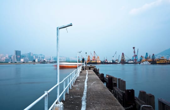 Deserted jetty at a foggy sea near a dutch city. hongkong