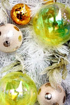 Christmas balls on white feathers.