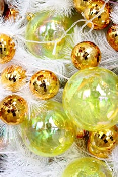 Christmas balls on white feathers.