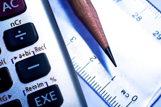 pencil and ruler and calculator to show math concept