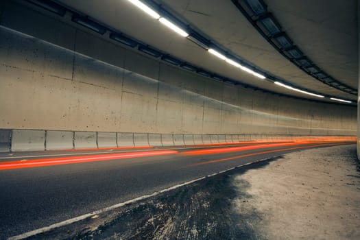 Car lights trails in a old tunnel