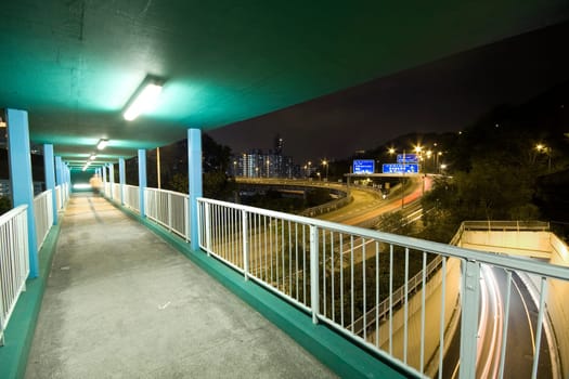 view on footbridge of modern urban city with Freeway Traffic at Night, hong kong