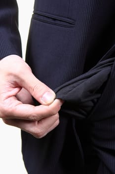 young male shows empty pockets in his trousers, business concept, studio shoot isolated on white background