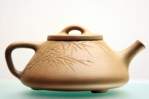 chinese teapot close up with green toned