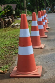 traffic warning cone in row to separate route in parking area