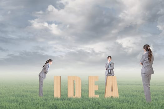 Concept of strategy, plan, idea etc with 3d wooden text and businesswoman under copyspace sky. The Asian woman is the same one.