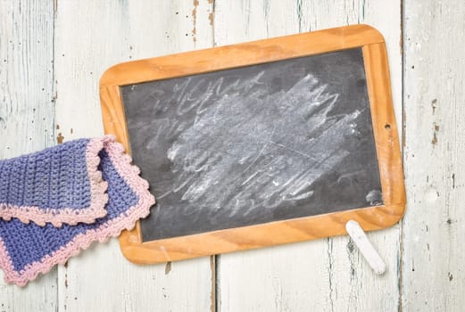 Old blackboard with chalk and cleaning rags