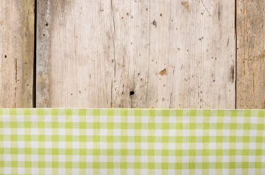 Green checkered tablecloth against a rustic wooden background