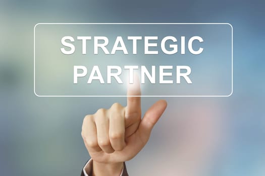 business hand pushing strategic partner button on blurred background