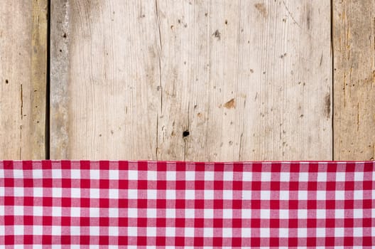 Red checkered tablecloth against a rustic wooden background