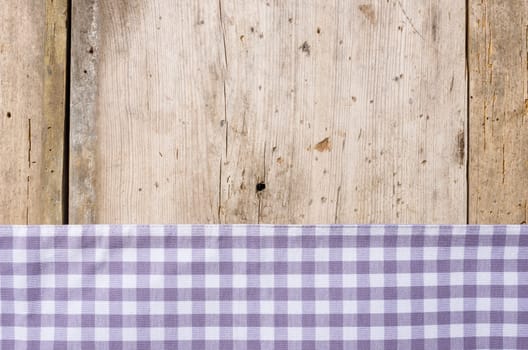 Purple checkered tablecloth against a rustic wooden background