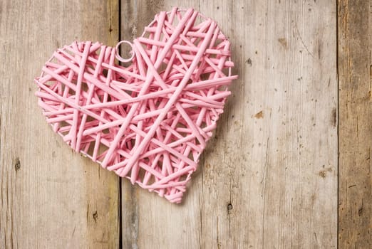 Pink heart in front of rustic wooden boards