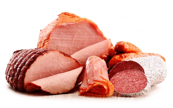 Assorted meat products including ham and sausages isolated on white