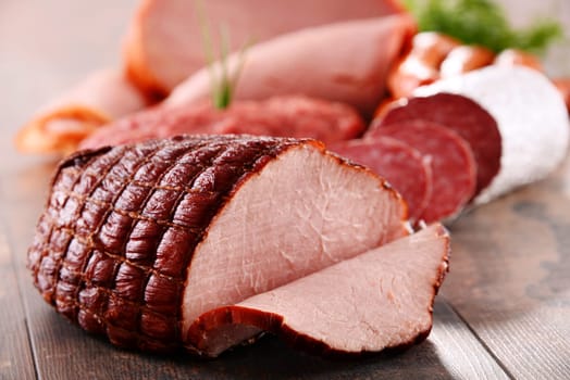 Assorted meat products including ham and sausages.