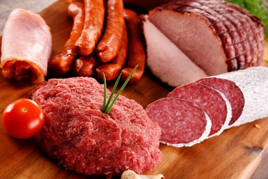 Assorted meat products including ham and sausages.