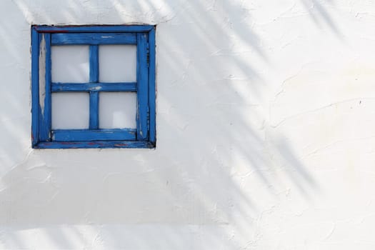 small wooden windows on the white wall