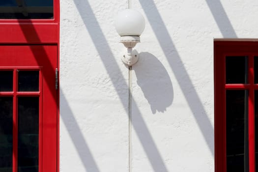 old street lamp with window on white wall