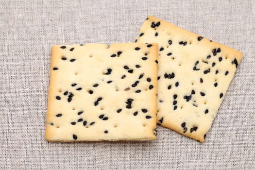 cracker with sesame as burlap background