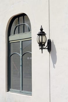 Old lamp lantern and window on the white wall