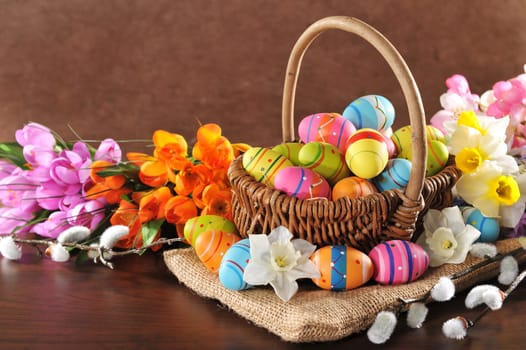 Easter nest with many painted Easter eggs,daffodils and palm kittens