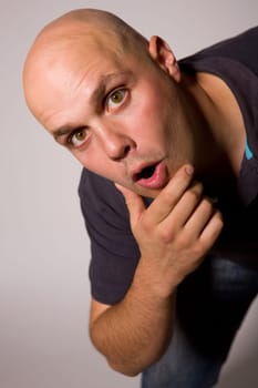 Portrait of young silly man on a dark background
