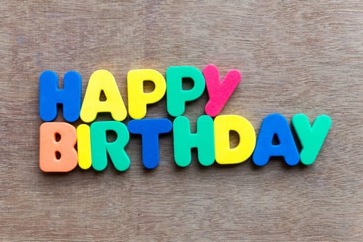 Happy birthday on wooden background