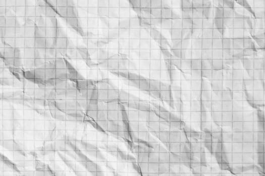 Part of the surface crumpled checkered paper. macro photo