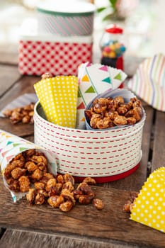 Sugar roasted almonds with cinnamon in little colorful paper bags