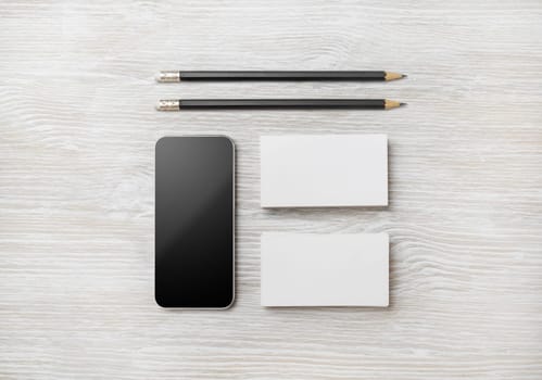 Branding stationery template. Blank business cards and pencil on light wood table background. Flat lay.