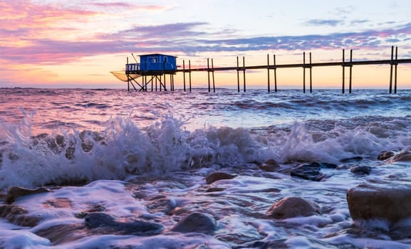 Huts of fishermen in the sunset resting on piles