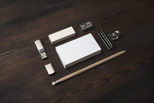 Blank branding identity set on wood table background. Business card, pencil, eraser and flash drive. Corporate stationery template.