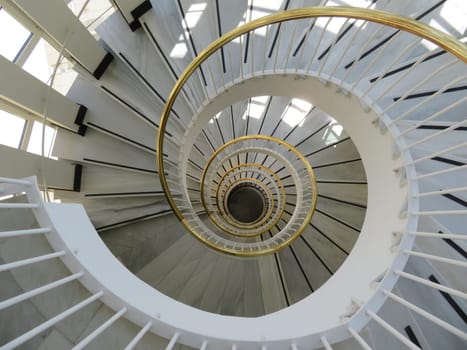 beautiful spiral staircase with golden handrails design circular shapes