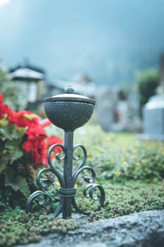 Iron holy water bowl on a cemetery