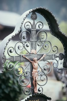 Iron crucifix with Jesus on a cemetery