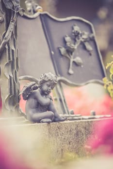 Iron angel on a grave at a cemetery