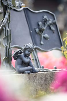 Iron angel on a grave at a cemetery