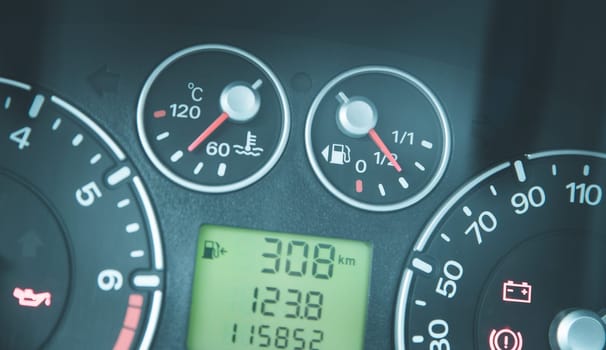 Close up picture of car dashboard with instruments and tachometer