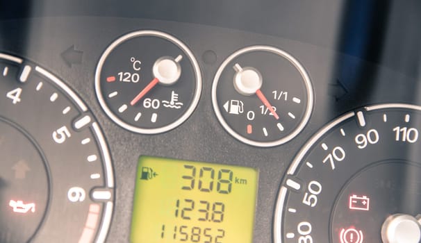 Close up picture of car dashboard with instruments and tachometer