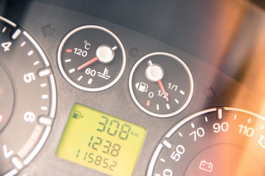 Close up picture of car dashboard with instruments and tachometer